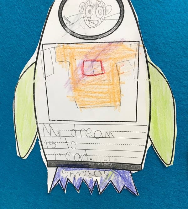 A child's drawing of a person in a rocket.