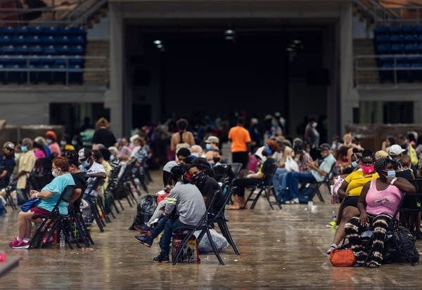 People wait to be evacuated before the arrival of Hurricane Laura.