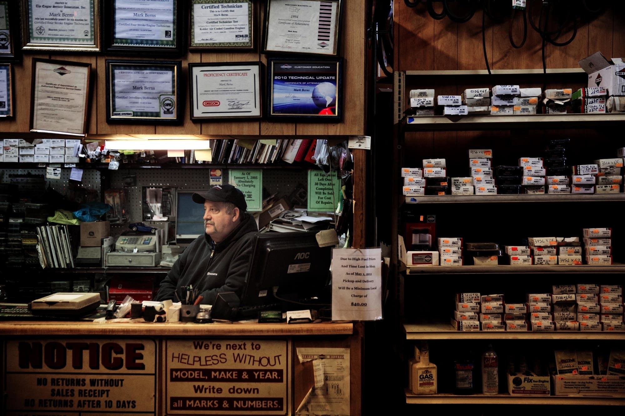 Mark Berns sits in his small engine repair shop