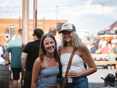 Two music fans pose for a photo.