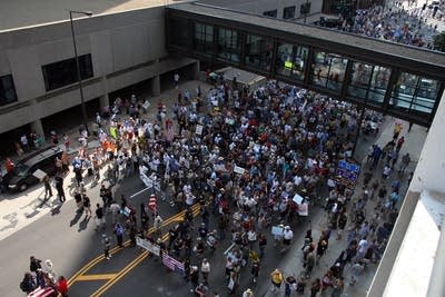 The protest crowd surges up 7th St in St. Paul