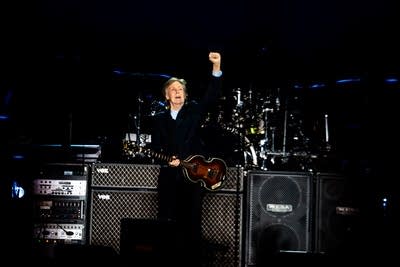 Paul McCartney performing on stage