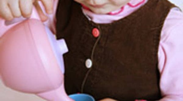 A girl plays with a toy tea set from Green Toys Inc., maker of eco-friendly toys.