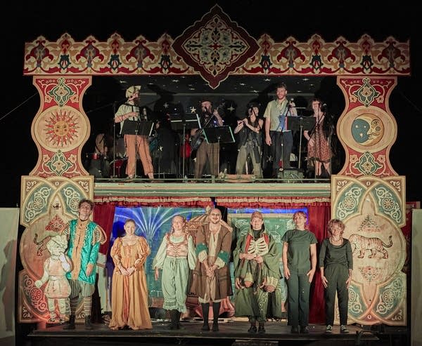Two layers of stage featuring musicians and actors
