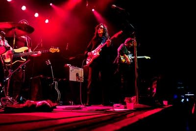 A band performing onstage in a music venue