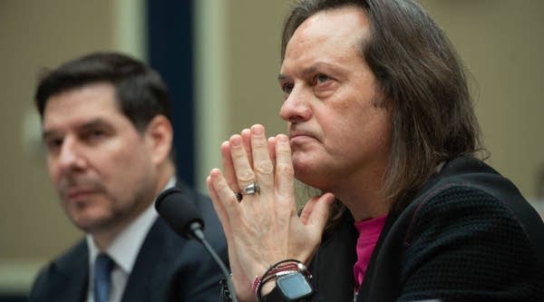 John Legere (R), CEO and President of T-Mobile US, and Marcelo Claure, Executive Chairman of Sprint, testify about the T-Mobile and Sprint merger during a House Energy and Commerce Subcommittee on Communications and Technology hearing on Capitol Hill in Washington, DC, February 13, 2019.