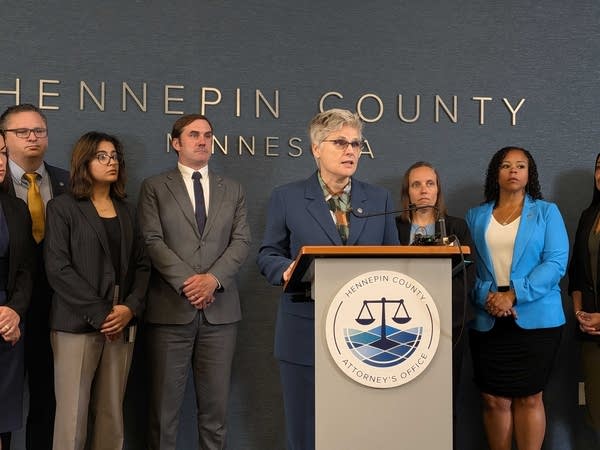 A group of people gather for a press conference.