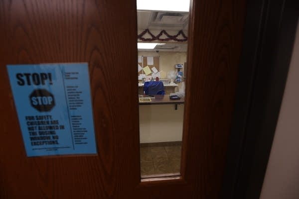 A door with a view through the window, showing medical equipment.