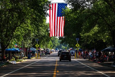 An American flag hangs over River St.