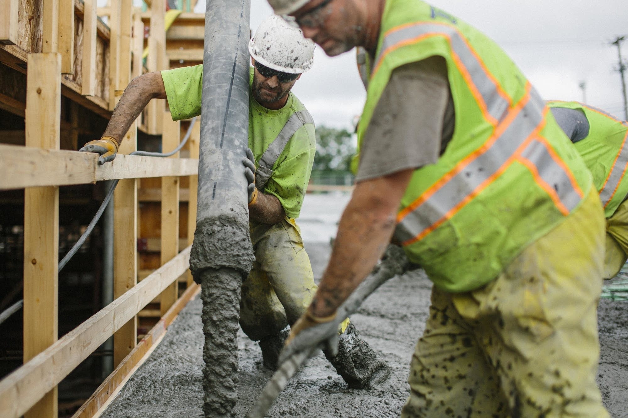 Thor employees pour concrete.