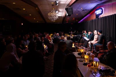 Lambchop performs seated on a stage.