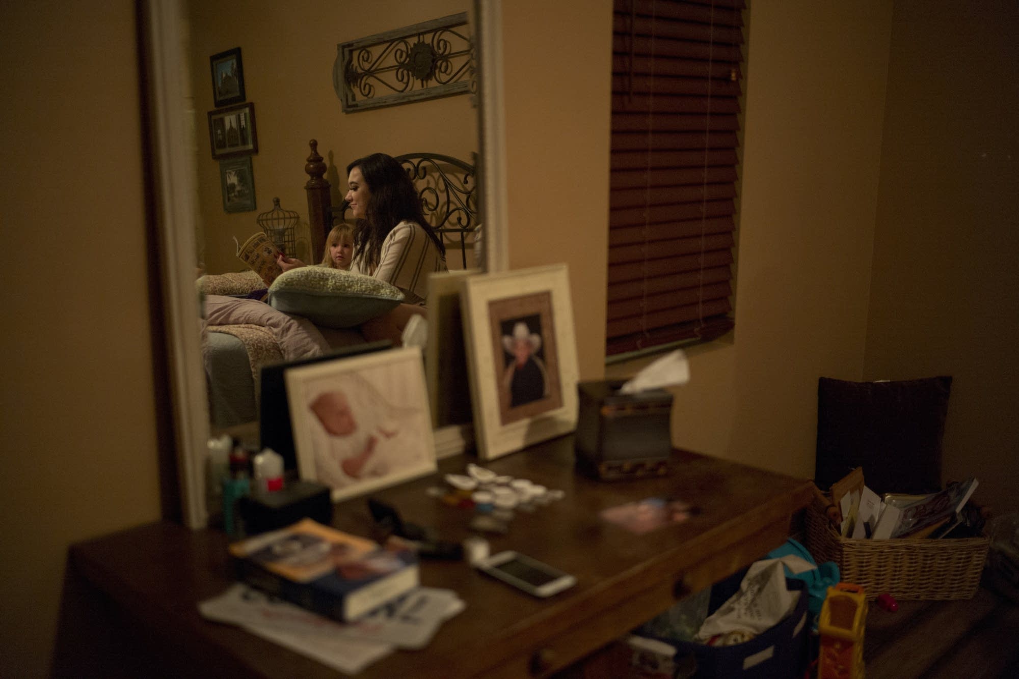 Megan Dealbert reads a bedtime story to her daughter Aubrey.