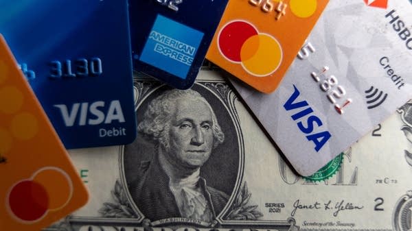 Credit cards spread out over a dollar bill