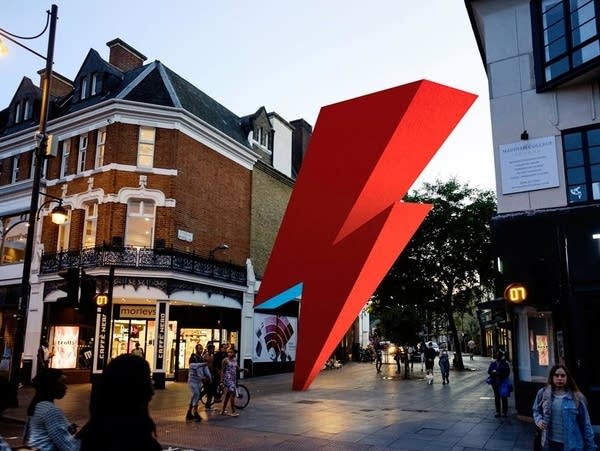 A photoillustration depicts a planned David Bowie tribute sculpture in Brixton, London, England