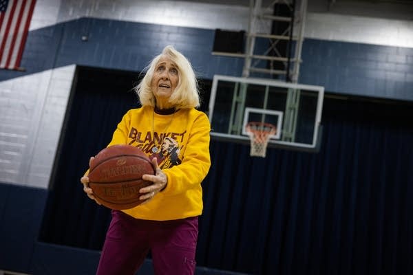 A woman prepares to shoot a basketball