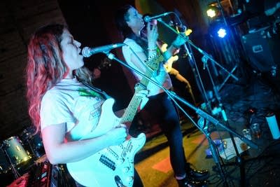 Two musicians performing onstage