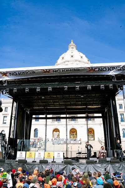 A hip-hop duo performing on an outdoor stage at a large rally