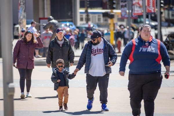 fans walk wearing Twins merchandise