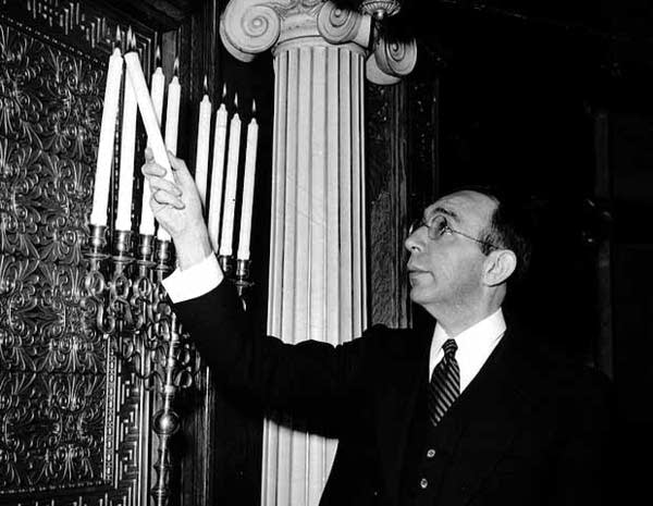 Rabbi Harry Margolis lights the menorah, 1943