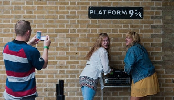 Tourists pose for photographs in front o