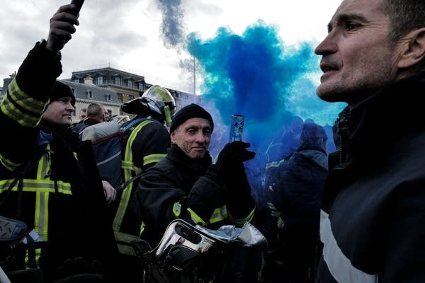 Firemen pose with flares during a rally in Lyon, south-eastern France as workers go on strike over the French President's plan to raise the legal retirement age. 