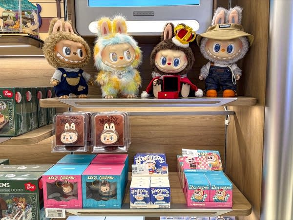 Labubu dolls and boxes on a shelf