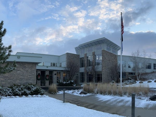 a brick building with snow covered ground