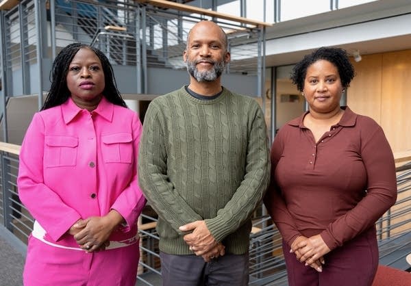 three people posing for a portrait