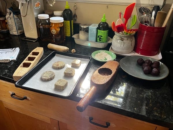 A tray of mooncakes sits in a kitchen.
