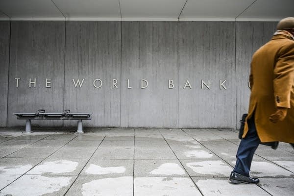 A person walks by the building of the Washington-based global development lender, The World Bank Group, in Washington. (Photo by Eric BARADAT/AFP/Getty Images)