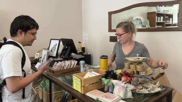 At Local Stitch in Baltimore, Natasha Ibrahim (right) sells supplies for sashiko, a decorative mending technique, to customer Nicolas Medina.