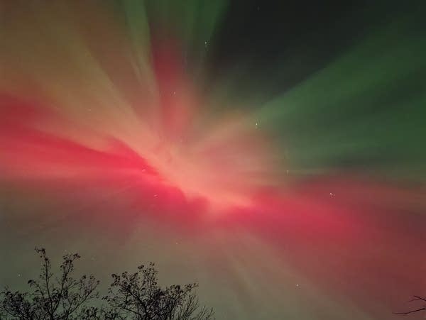 Red and green lights reach across the night sky.