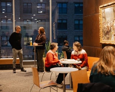 People gather and converse at a social event