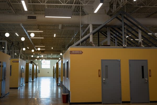 A row of tiny homes inside a large building