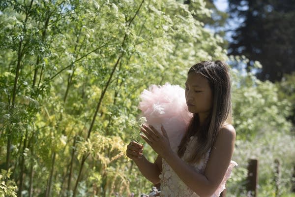 A woman holding a flower