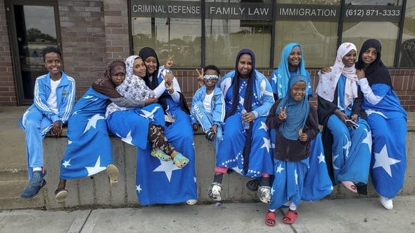 Family members wearing Somali flag outfits pose for photo