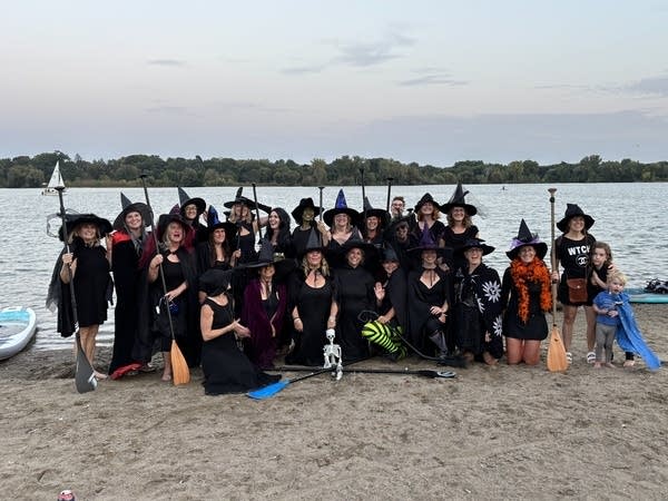 Minneapolis witch coven takes to their paddleboards for spooky lake gathering