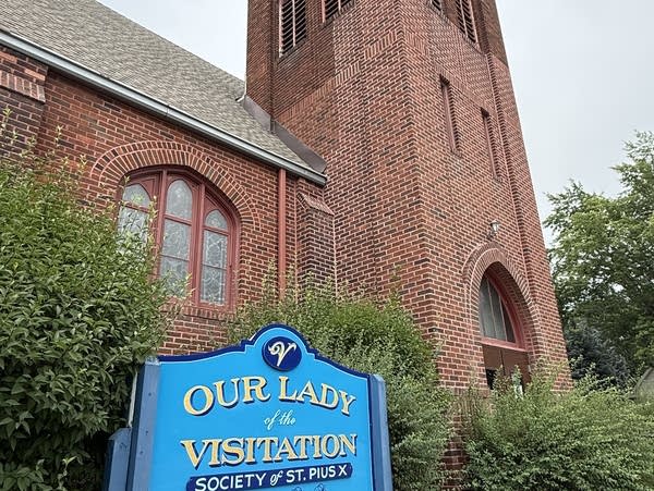 A photo of the sign and exterior of a brick church