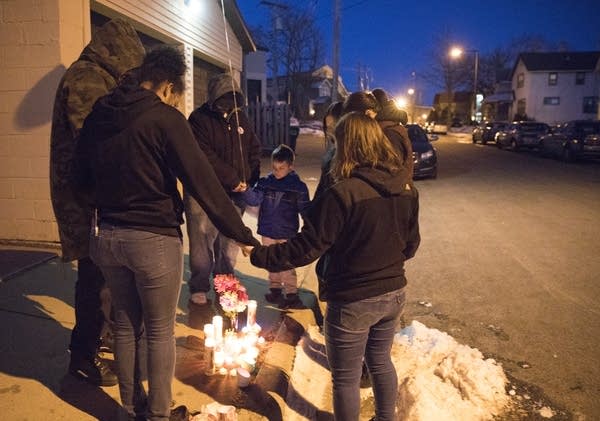 Community members hold a moment of silence