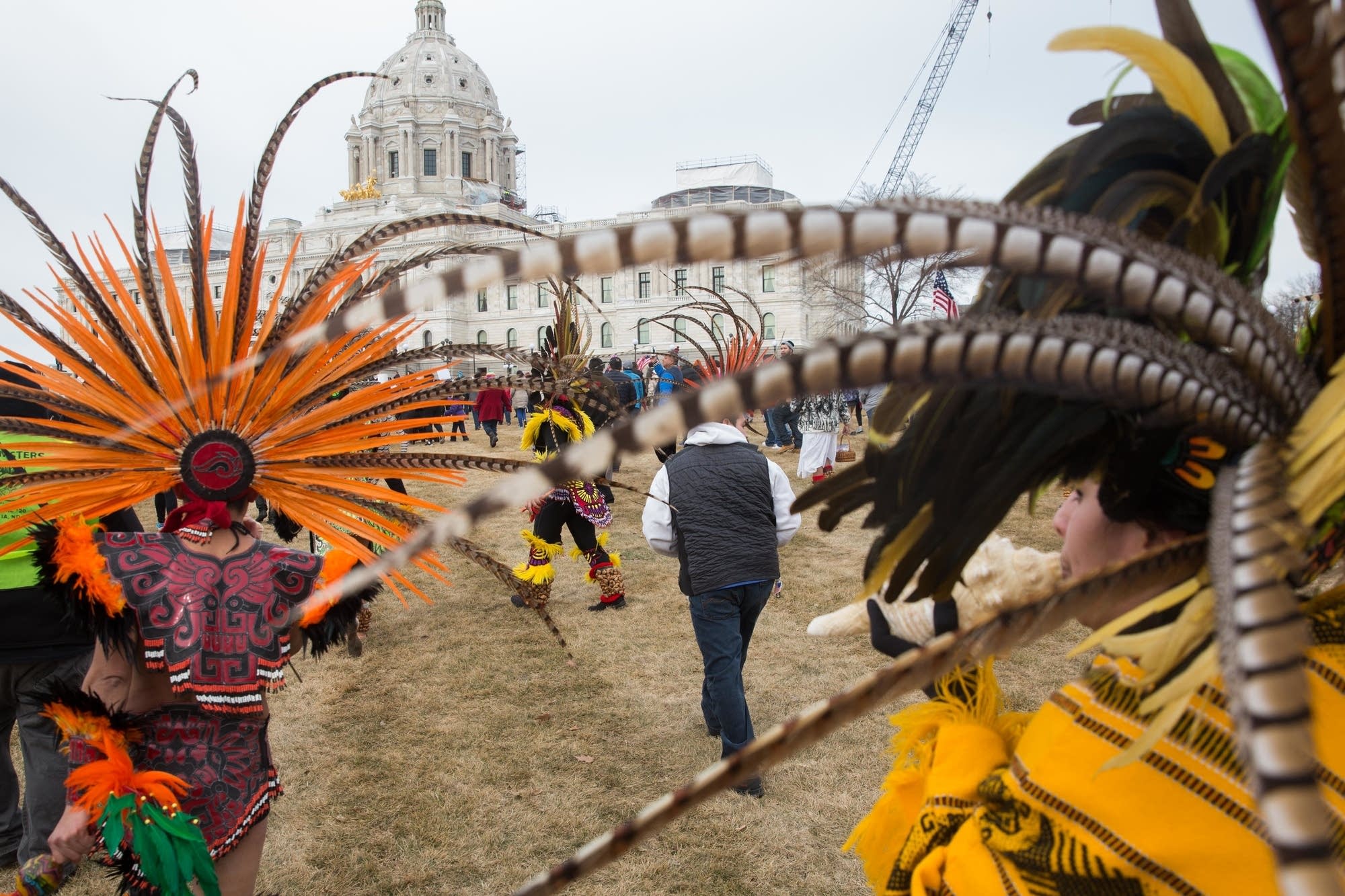 Indigenous dancers lead a group of protesters to the Capitol.
