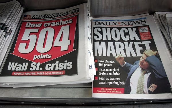 Newspapers feature stock market numbers on front page. (Photo by Mario Tama/Getty Images)