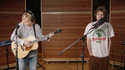 Two musicians performing in a recording studio