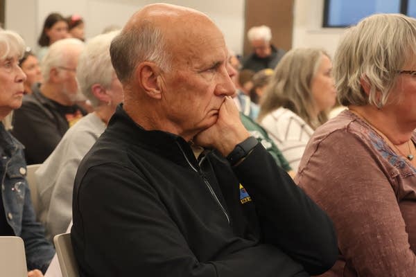 A man looks on in a crowd