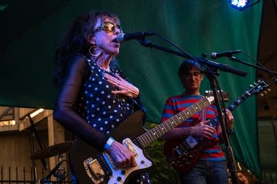 a rock band performing on an outdoor stage