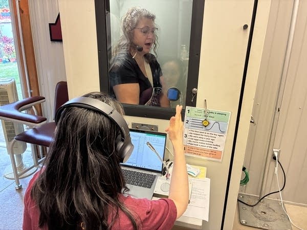 A person talks into a microphone