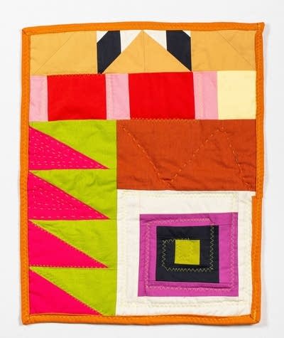 Textile artwork featuring triangles and squares in bold pinks, greens, oranges and reds.