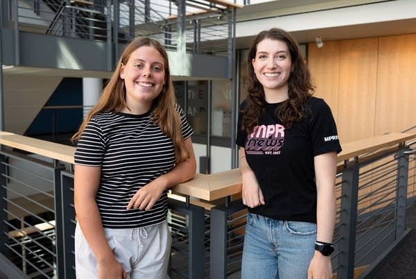 Two women pose for a portrait