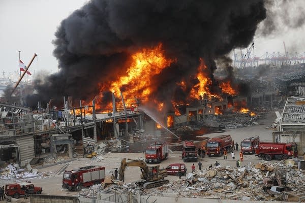 A fire burns at a port.