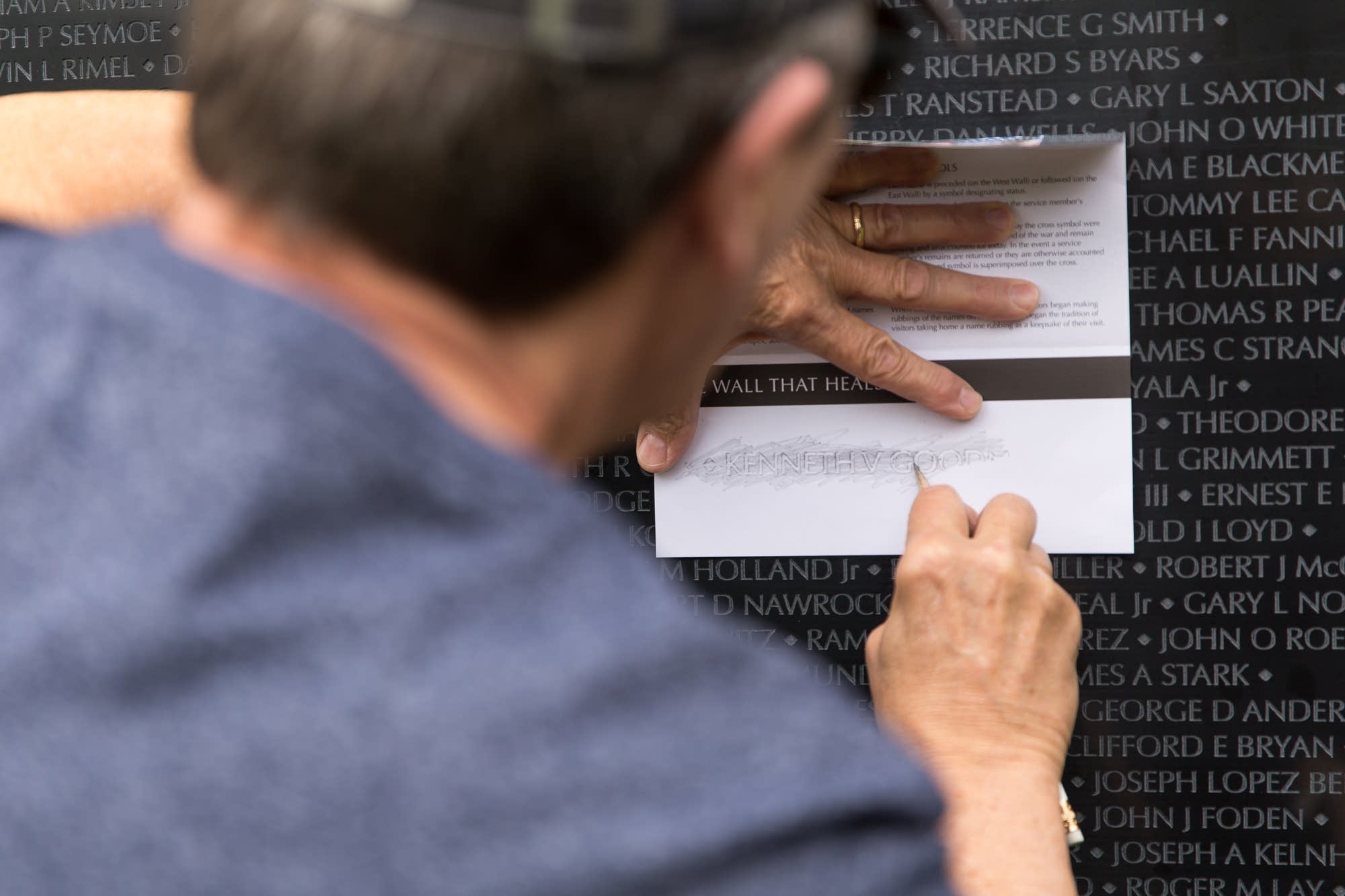 Bill Bandelin traces the name of Vietnam veteran Kenneth V. Goodman.