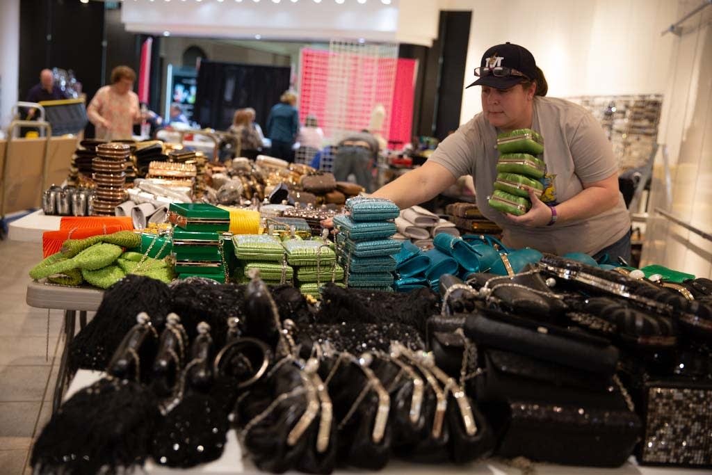 Heather Rowe sorts handbags to prepare for the princess event.